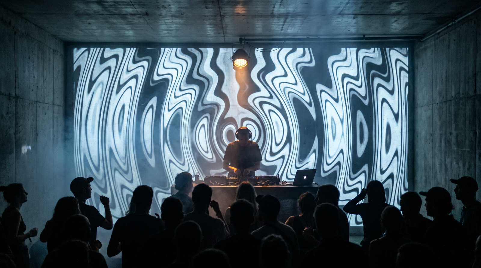 Intimate Berlin techno venue with SlopMotion ripple visuals video-mapped on the concrete wall behind the DJ